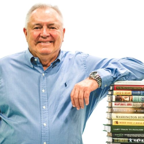 Les Standiford with stack of books