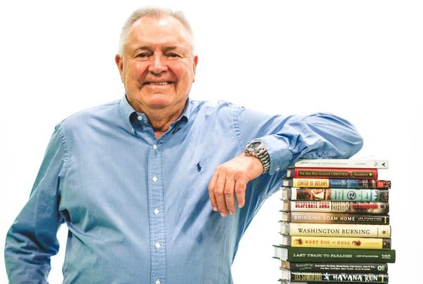 Les Standiford with stack of books